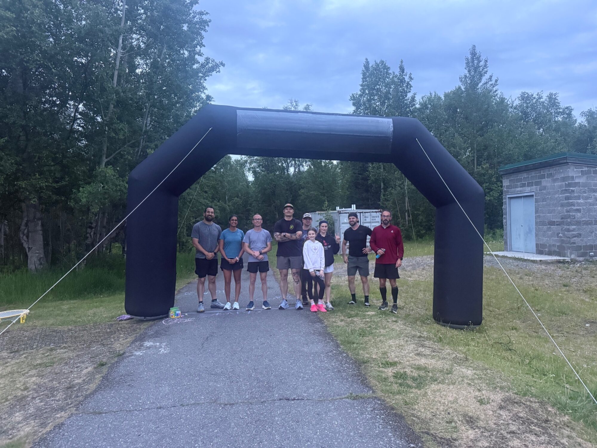 Participants gathered beneath the starting arch at the Toughest Alive Midnight Sun Block Party.